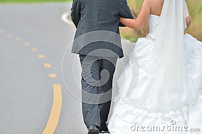 Bride and groom walking away Stock Photo