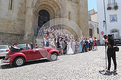 Bride, groom and wedding guests in front of the church Se Velha Editorial Stock Photo