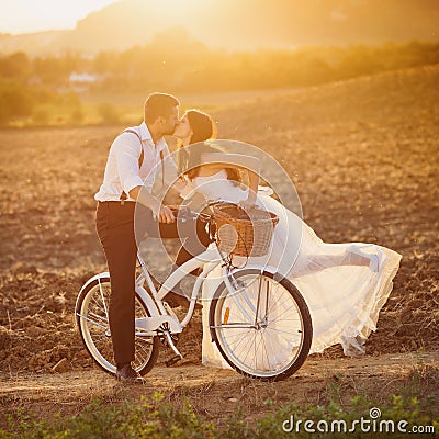 Bride and groom with a white wedding bike Stock Photo