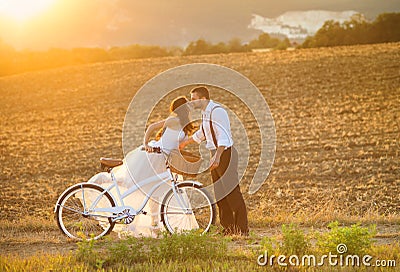 Bride and groom with a white wedding bike Stock Photo