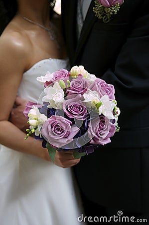 Bride holding her bouquet with groom Stock Photo