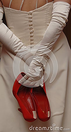 A bride holding Red Shoes Stock Photo