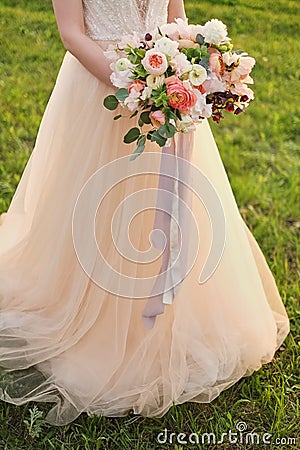 Bride holding a wedding fine-art bouquet in pastel pink colors. closeup. Stock Photo