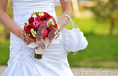 Bride holding wedding flowers Stock Photo