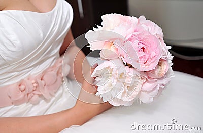 Bride holding wedding flowers Stock Photo