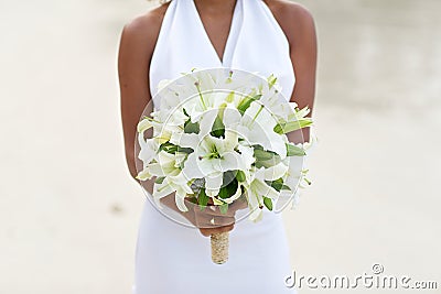 Bride holding white lily flower wedding bouquet Stock Photo