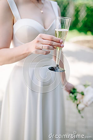 The bride holds a glass of delicious champagne Stock Photo