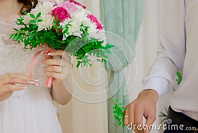 The bride holds a wedding bouquet in her hand. Stock Photo