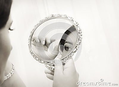 Bride looking in the mirror, vintage style Stock Photo