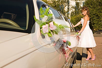 Bride is opening limousine door Stock Photo