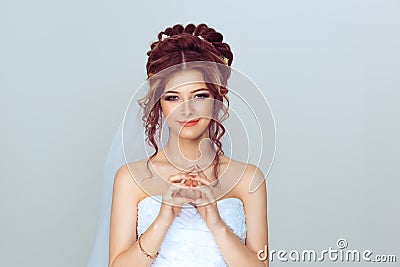 Bride plotting. Closeup portrait sneaky, sly, scheming young woman plotting revenge plan, prankster on light blue wall Stock Photo