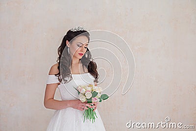 Bride Princess stands in a wedding dress with flowers Stock Photo