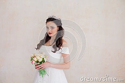 Bride Princess stands in a wedding dress with flowers Stock Photo