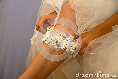 Bride Putting On Garter Stock Photo