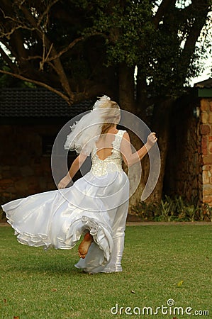 Bride running away Stock Photo