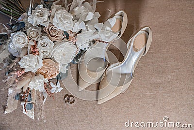 bride`s bouquet, shoes, wedding rings and a set of invitations. The bride`s accessories. Wedding morning Stock Photo