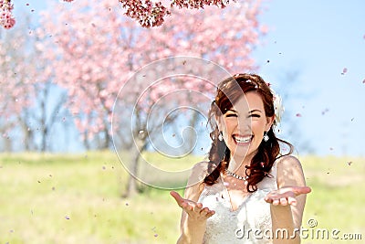 Bride Showered by Cherry Blossom Petals Stock Photo