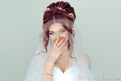 Bride smiling shy. Beautiful woman spouse toothy smile hand on face isolated light green wall background. Happiness getting Stock Photo