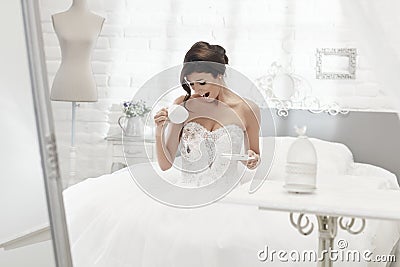 Bride spilling coffee on wedding dress Stock Photo