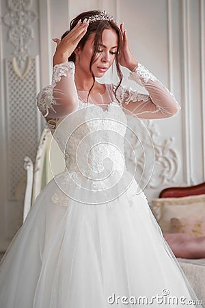 The bride straightens her wedding tiara on her head Stock Photo