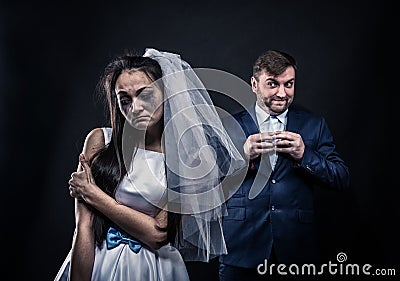Bride with tearful face and groom with sly smile Stock Photo