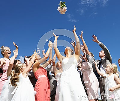 Bride Throwing Bouquet For Guests To Catch Stock Photo