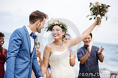 Bride throwing flower bouquet to guests Stock Photo