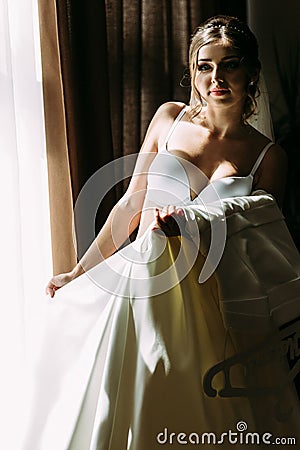 Bride in the underwear and white bridal dress Stock Photo