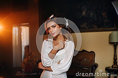 A bride in underwear and a white robe in the interior of a Villa in Italy at a wedding.morning of the bride in Tuscany.boudoir Stock Photo