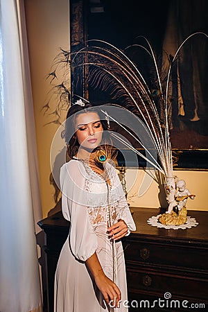 A bride in underwear and a white robe in the interior of a Villa in Italy at a wedding.morning of the bride in Tuscany.boudoir Stock Photo