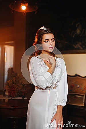 A bride in underwear and a white robe in the interior of a Villa in Italy at a wedding.morning of the bride in Tuscany.boudoir Stock Photo