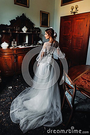 A bride in underwear and a white robe in the interior of a Villa in Italy at a wedding.morning of the bride in Tuscany.boudoir Stock Photo