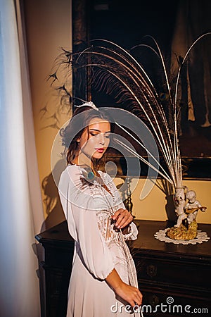 A bride in underwear and a white robe in the interior of a Villa in Italy at a wedding.morning of the bride in Tuscany.boudoir Stock Photo