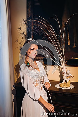 A bride in underwear and a white robe in the interior of a Villa in Italy at a wedding.morning of the bride in Tuscany.boudoir Stock Photo