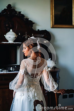 A bride in underwear and a white robe in the interior of a Villa in Italy at a wedding.morning of the bride in Tuscany.boudoir Stock Photo