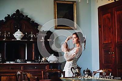 A bride in underwear and a white robe in the interior of a Villa in Italy at a wedding.morning of the bride in Tuscany.boudoir Stock Photo