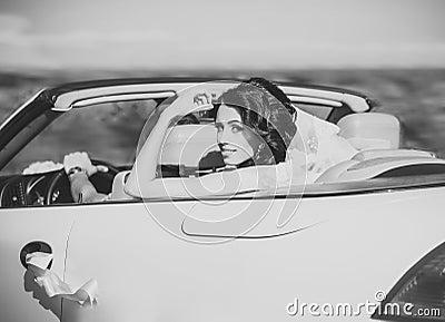 Bride in veil sit in white car cabriolet, wedding Stock Photo