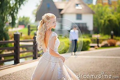 The bride is waiting for the groom before the meeting. Loving wedding couple in the summer on the square in the city of Dnipro, Uk Stock Photo