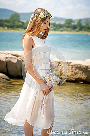 Bride with wedding crown and bouquet of seashels Stock Photo