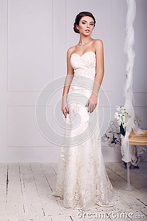 Bride in wedding dress posing beside a decorated swing Stock Photo