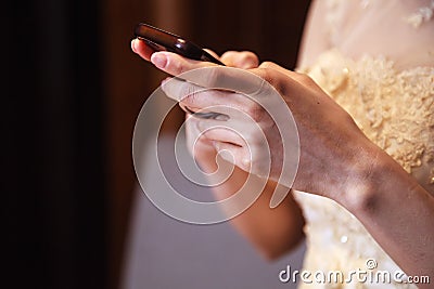 Bride in wedding gown using smart mobile phone, Shopping and Communicating with digital technology. Modern Trend, Lifestyle, Stock Photo