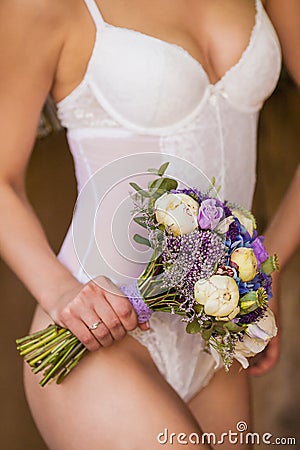 Bride in a white underwear with a wedding bouquet Stock Photo