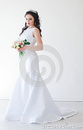 Bride in white wedding dress with a bouquet of flowers Stock Photo