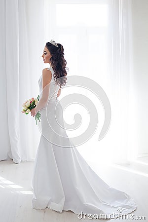 Bride in white wedding dress with a bouquet of flowers Stock Photo