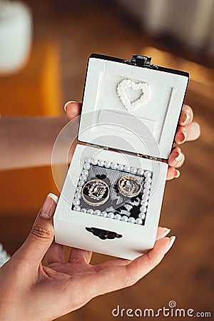 Bridesmade holding a white box with wedding rings Stock Photo