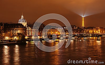 The bridge of art, Institute of France and the Eiffel Tower in the background. Editorial Stock Photo