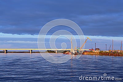 Bridge and boat with barge on the Nadym river in Siberia Stock Photo