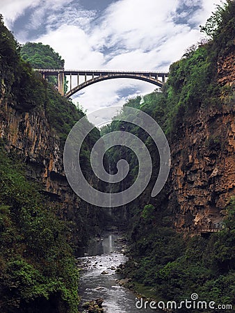 A bridge on the canyon and waterfall with sunny blue sky Stock Photo