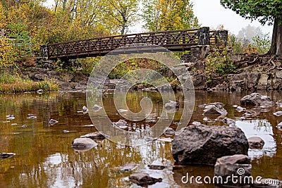 Bridge crossing the Gooseberry River in fall, at Gooseberry Falls State Park Minnesota Stock Photo