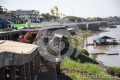 Bridge damage broken and thai worker working use backhoe machinery demolish remove and build new building at Nongkai city on Editorial Stock Photo